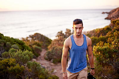 Buy stock photo Trail, travel and hiking with man in nature for explore, summer vacation and adventure. Health, trekking and ocean with person outdoors on path for wellness, fitness journey and eco tourism.