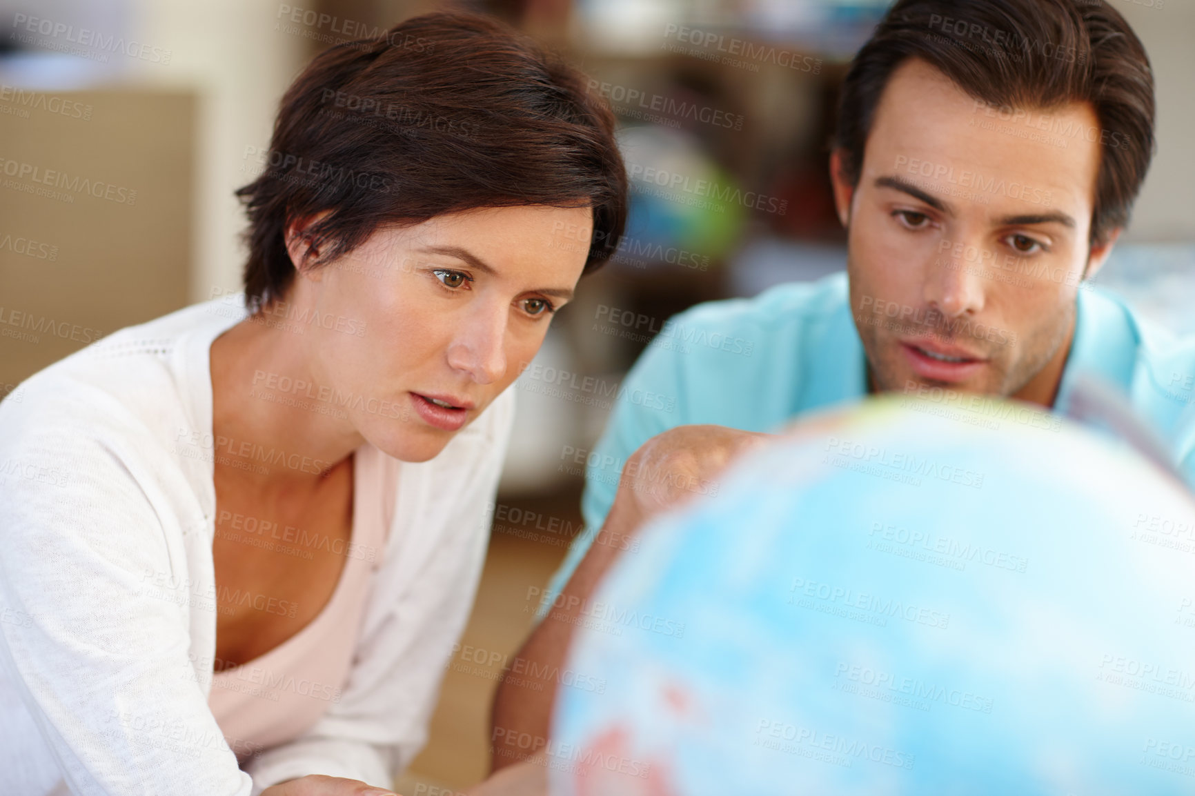 Buy stock photo Couple, planning and world in home for travel, vacation location and destination choice for trip. Man, woman and globe map for holiday decision, journey and navigation with earth for tourism together