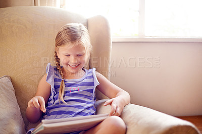 Buy stock photo Tablet, relax and child on sofa in home playing educational online game for learning on weekend break. Happy, website and girl kid on digital technology watching movie on streaming app in living room