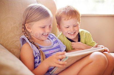Buy stock photo Bonding, smile and children with tablet, comfortable and streaming of movies in home, love and siblings. Browsing, brother and online with sister in lounge, boy and girl with tech for film in house