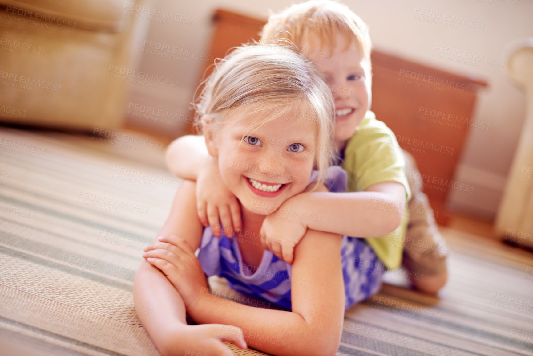 Buy stock photo Hug, girl and boy playing with siblings in home for bonding, love and happiness in childhood. Fun, games and portrait on living room floor for playful children with brother and sister in family house