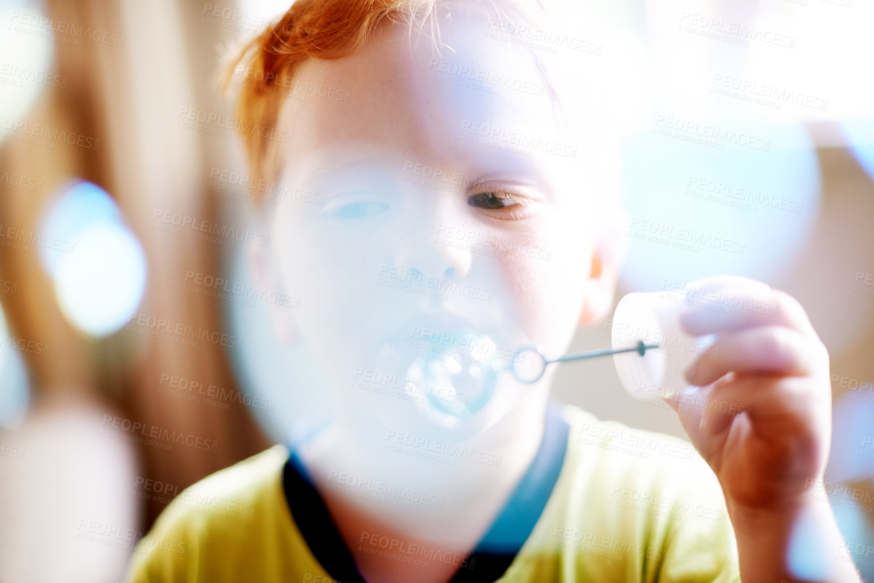 Buy stock photo Boy, child or blowing bubbles with wand for sensory stimulation, growth development or creative activity. Bokeh, person or learning with liquid soap for playing fun game, coordination or motor skills