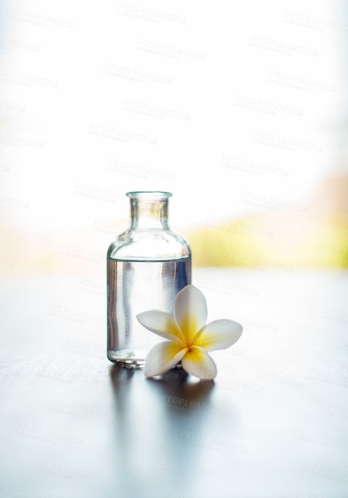 Buy stock photo Wellness, mockup and essential oil with flower on table for skin health, healthy body and aromatherapy massage. Interior space, cosmetics and healing product for skincare, antioxidants and anti aging