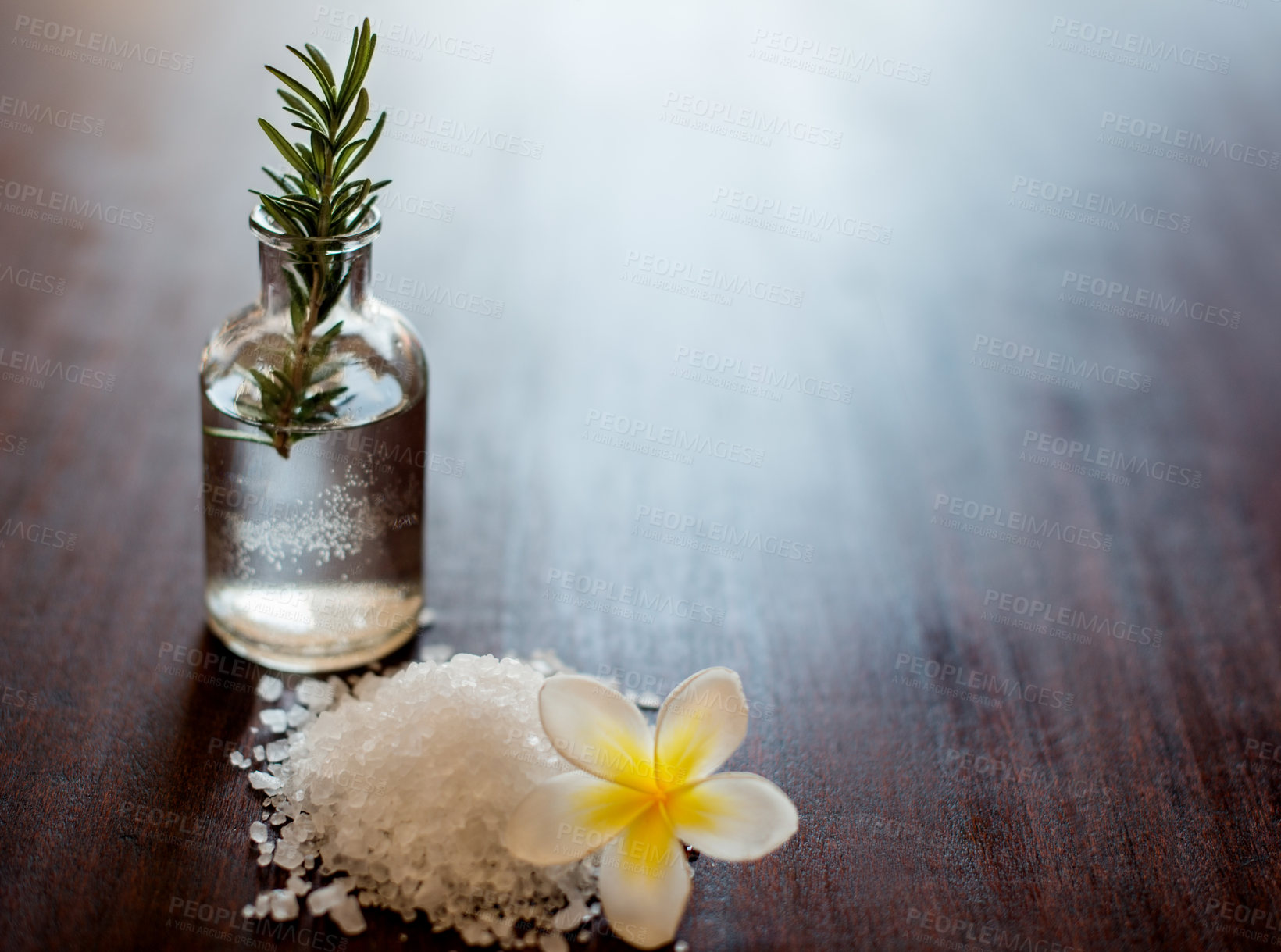 Buy stock photo Flower, herbs and bath salt in spa for beauty, wellness and skincare treatment with rosemary. Salon aesthetic, mockup space and essential oil for cosmetics, self care and health for calm or peace