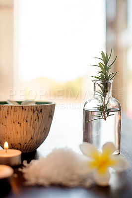 Buy stock photo Wellness, spa and rosemary essential oil with salt on table for aromatherapy treatment, candles or swedish massage. Interior space, luxury clinic and empty room with organic products for decoration