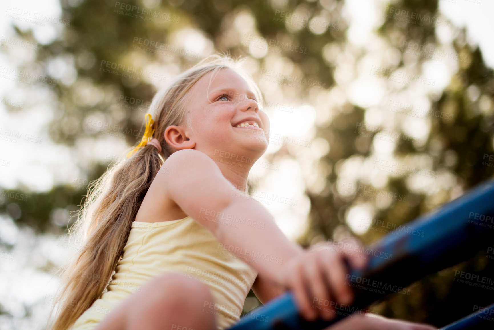 Buy stock photo Happy, girl and outdoor playground with carousel, adventure and playful park exercise. Smile, child and fun games with motor growth, summer holiday and merry go round low angle for childhood activity