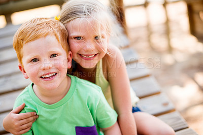 Buy stock photo Smile, portrait and children hugging in park for bonding, connection or adventure together. Love, siblings and kids embracing outdoor on playground for development, growth and exploring in nature.