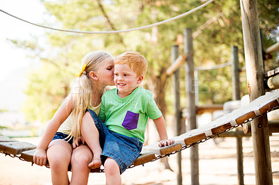 Buy stock photo Bridge, jungle gym and kiss with children friends outdoor in nature together for affection or love. Family, happy or smile with boy and girl kids at playground in forest for bonding or playing