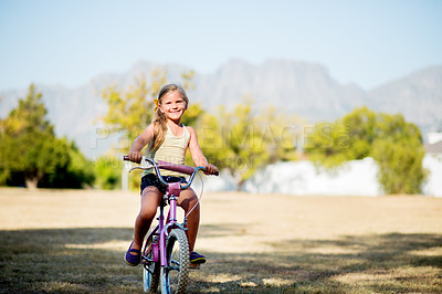 Buy stock photo Girl, child portrait and outdoor for riding bicycle, learning development and practice in neighborhood. Happy, bike and female person for travel adventure on weekend, kid and holiday for childhood
