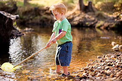 Buy stock photo Kid, river and play with fishing net for adventure, vacation and holiday in countryside. Hobby, catch and boy child in water with equipment for learning, explore and travel by lake in nature outdoor