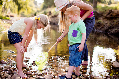Buy stock photo Family, fishing and mother with kids, river and playing outside with weekend break. Parent, mama and children with siblings, net and activity with hobby, bonding together and recreation with fun