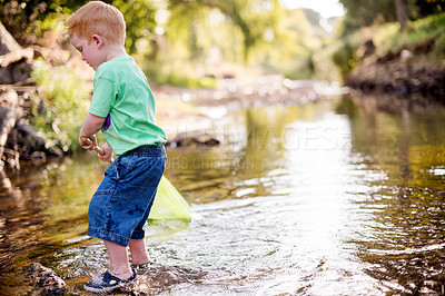 Buy stock photo Kid, river and play with fishing net on vacation, holiday and adventure in countryside. Hobby, catch and boy child in water with equipment for learning, explore and travel by lake in nature outdoor