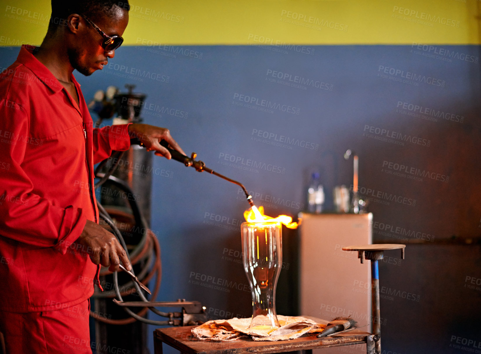Buy stock photo Glass, art and black man in workshop with torch for small business, craft or handmade technique. Creative, product shape or glassblower in factory for sustainable process, design or bottle sculpture