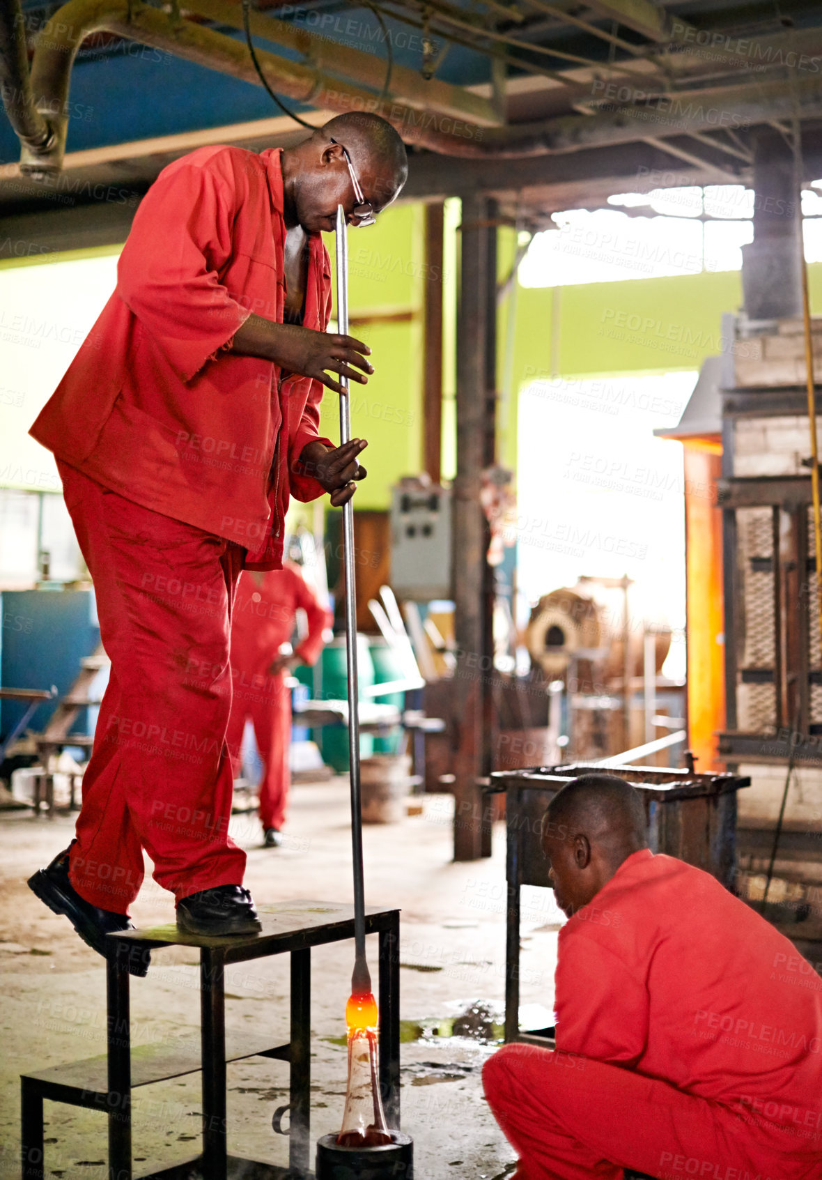 Buy stock photo Glassblower, craft and people in factory for heating production or equipment for professional skills. Labor, workshop and molding object with tools for metalwork, manufacturing or shape for teamwork