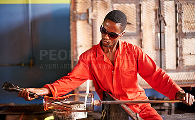 Buy stock photo Glass, blowing and black man in workshop with safety, small business or handmade craft form. Art, product shape and glassblower in factory for sustainable process, bottle design and sculpture tools