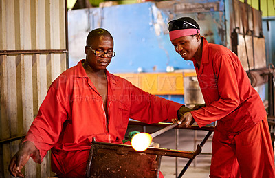 Buy stock photo Glassblower, craft or men in factory for heating production or equipment for professional skills. Labor, workshop or African people molding object shape with manufacturing tools for plant or teamwork