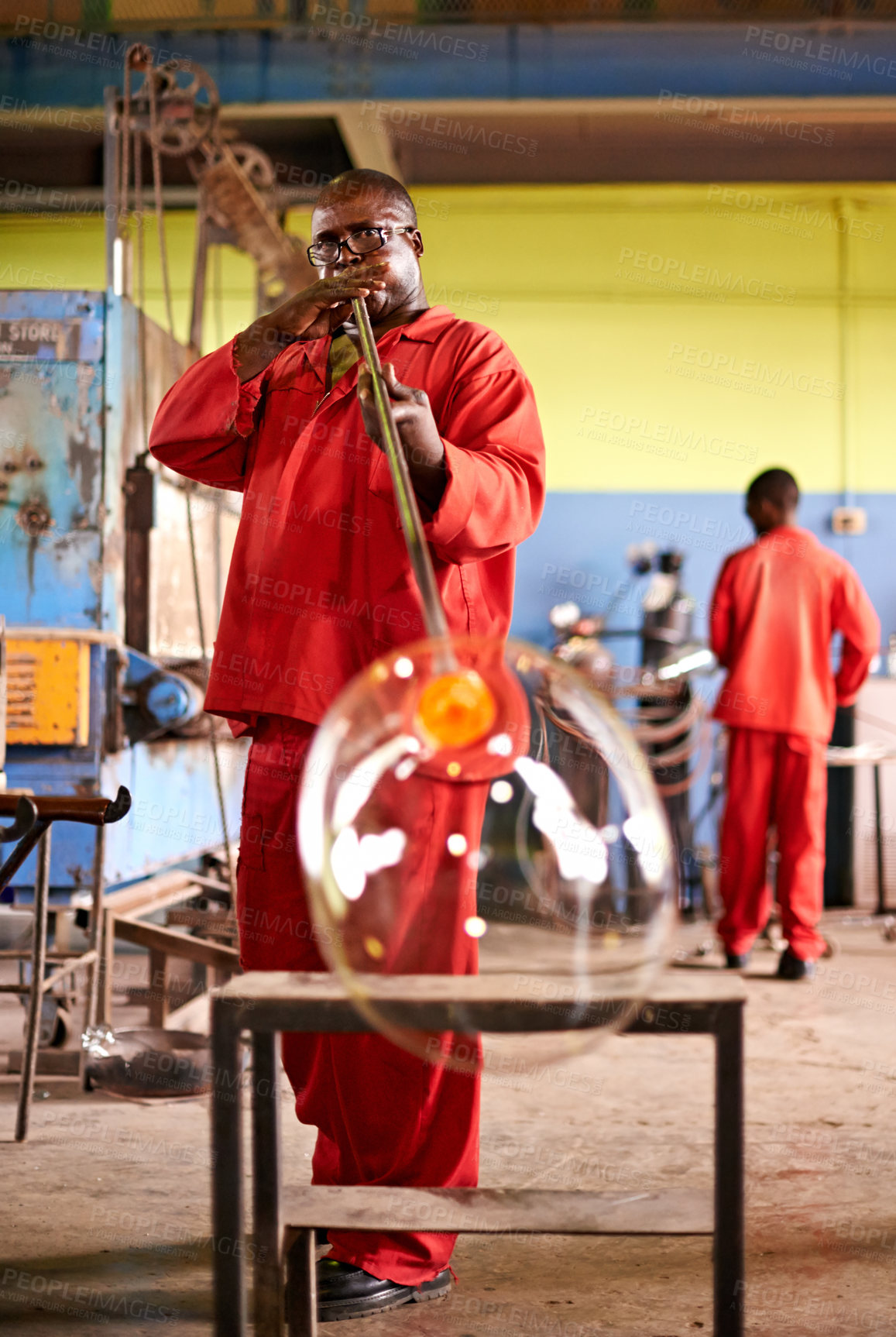 Buy stock photo Glass factory, man and glassblower for manufacturing, production process and industry. Glassware, tools and worker with equipment for craft, glow and African gaffer with blowpipe for art in workshop