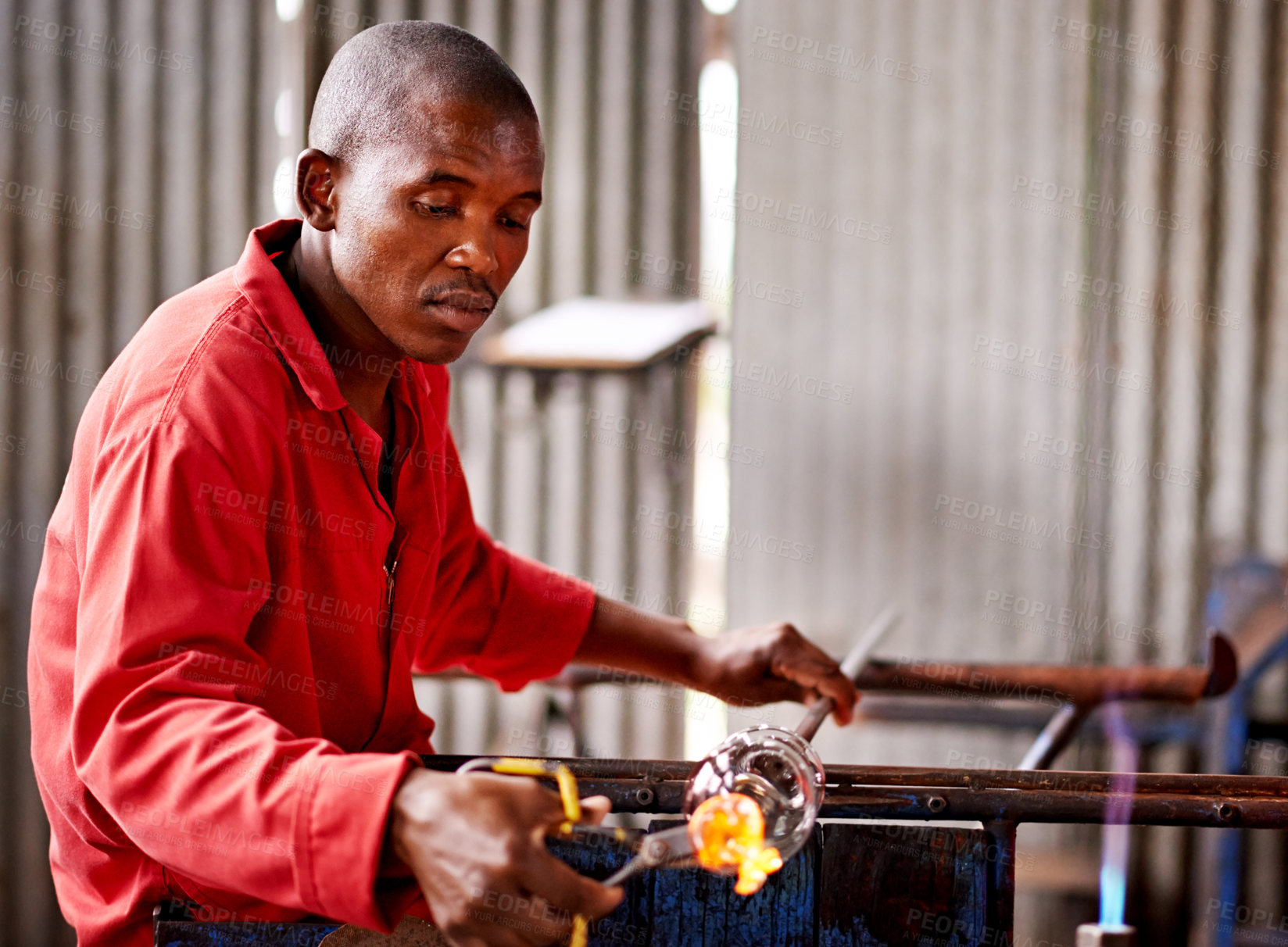 Buy stock photo Glass blowing, small business and black man in workshop for creative artist, craft and handmade shape. Art, product process and glassblower in factory for sustainable project, design and heat tools