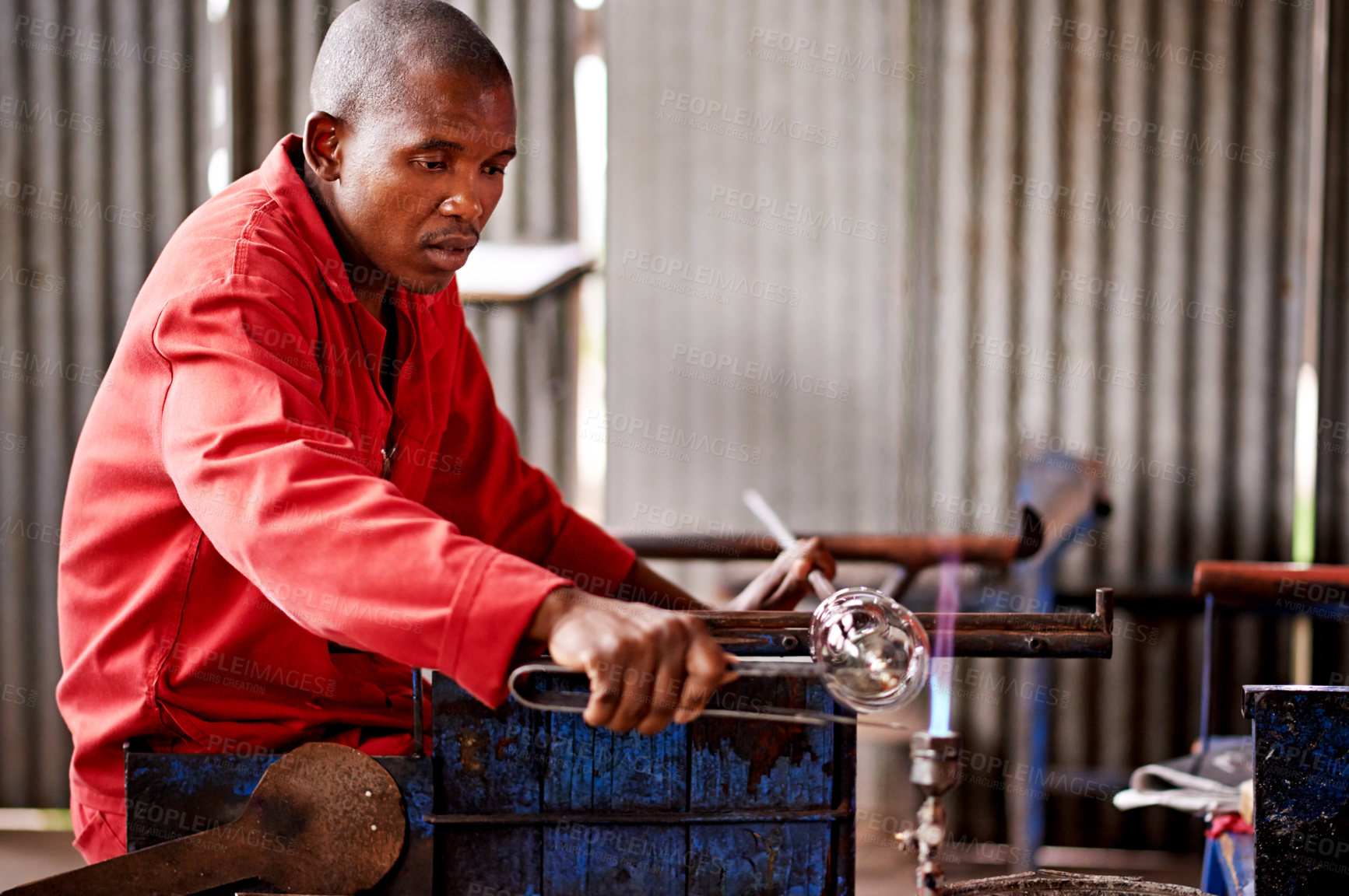 Buy stock photo Glassblowing, process and shape with black man artisan in manufacturing or production workshop. Art, creative and design with professional glassblower in factory, forge or plant for craftsmanship