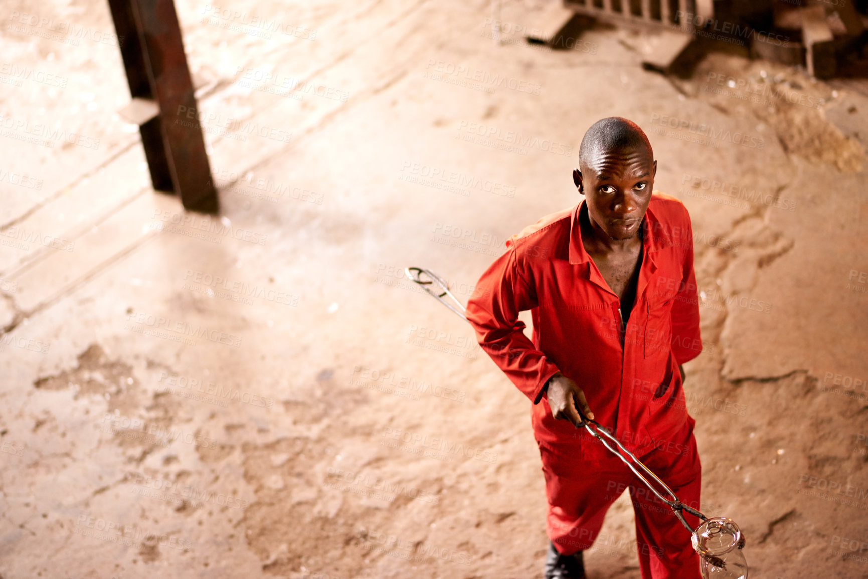 Buy stock photo Above, portrait and black man with product, glassblower in factory and equipment for productivity. African person, face and employee in workshop, tools and skills with craftsmanship or local industry