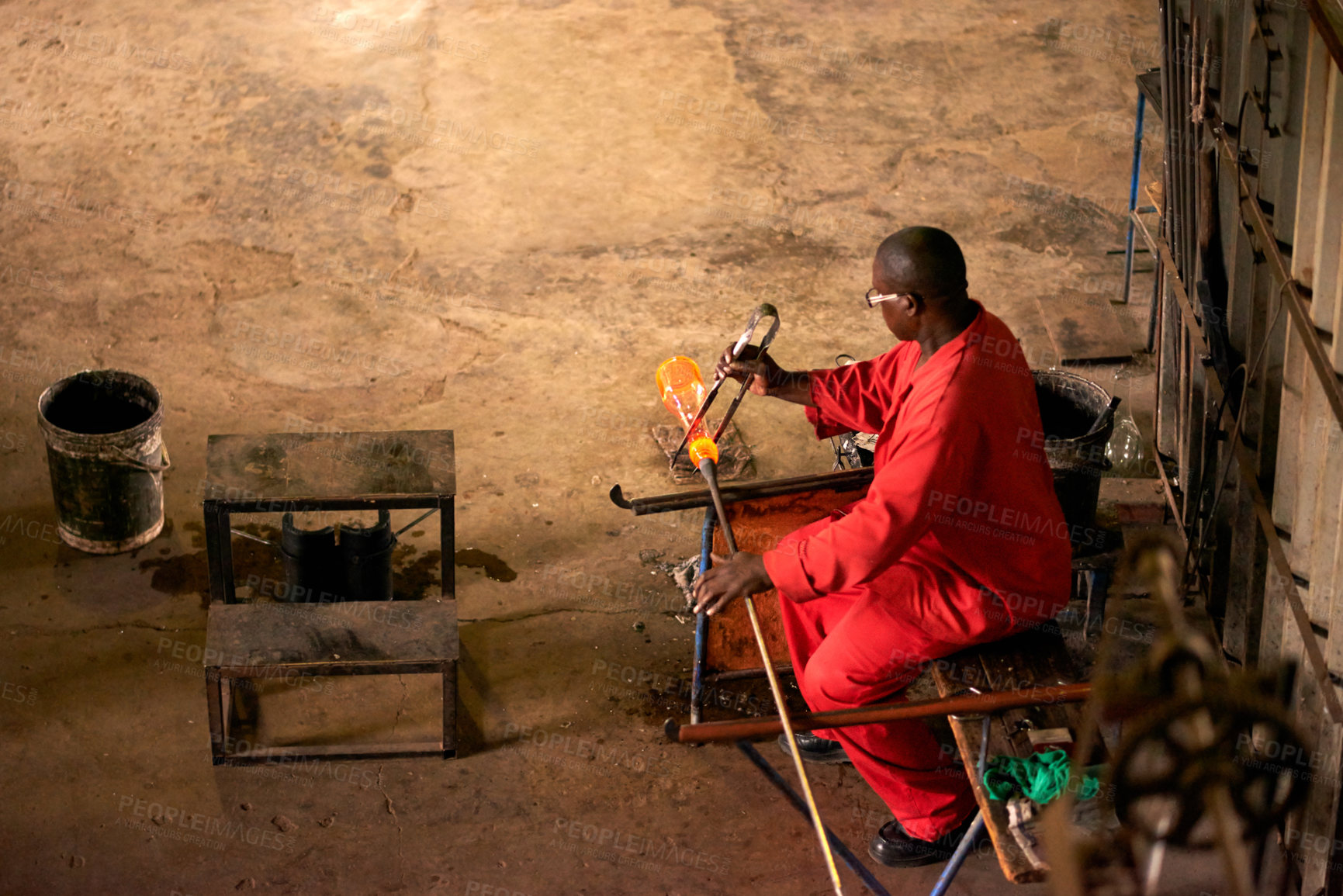 Buy stock photo Above, glassblower and black man in factory, equipment  and process with craftsmanship, material and industry. Person, technique and employee in workshop, manufacturing and tools with productivity