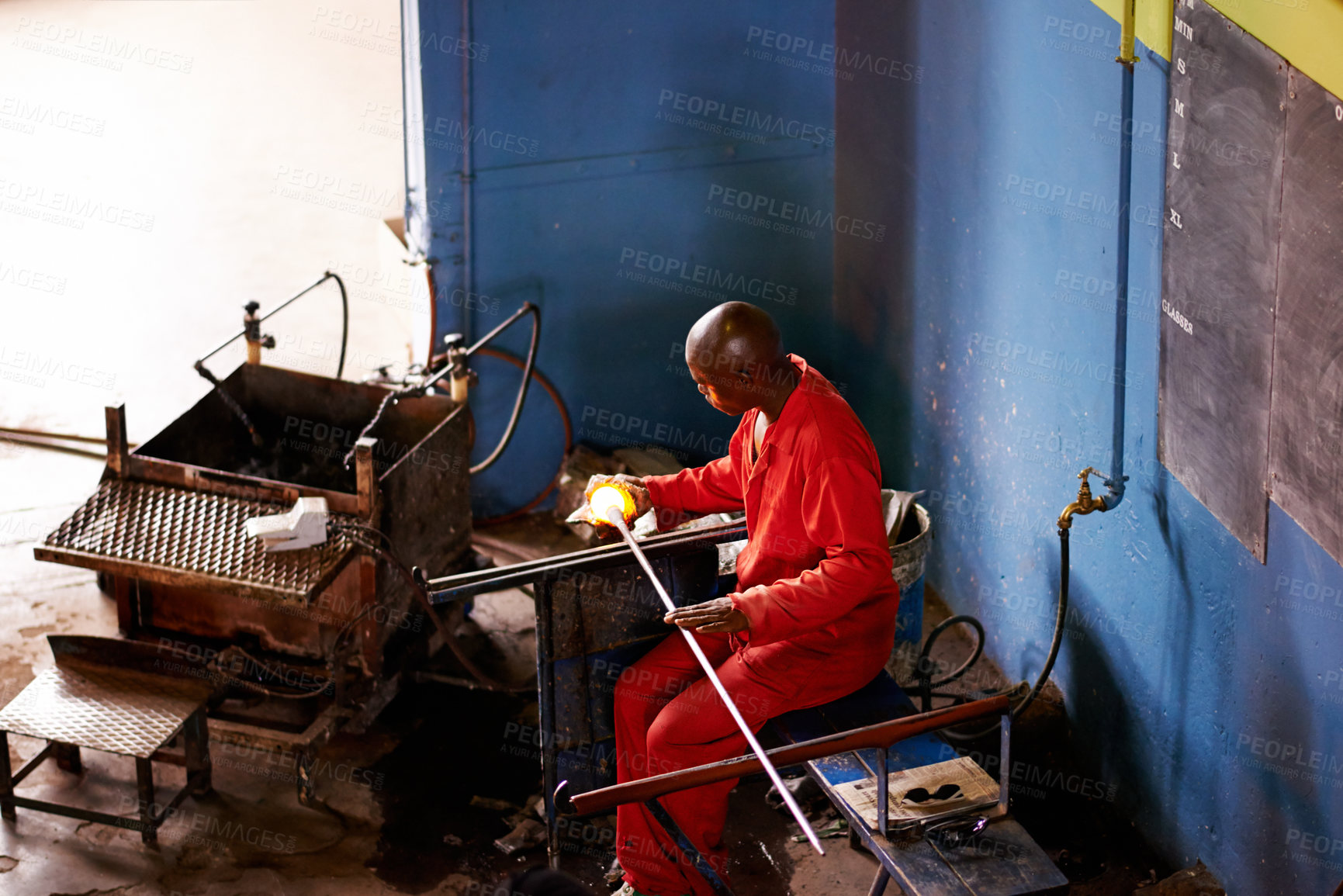Buy stock photo Glassblower, heating and man in workshop with production and equipment for professional craft. Labor, factory top view and molding object with tools for metalwork, manufacturing and forge for shape