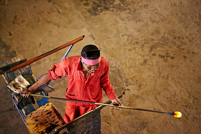 Buy stock photo Above, glassblower and black man in warehouse, tools and heat with craftsmanship, material and manufacturing. African person, technique and employee in workshop, productivity and handmade artwork