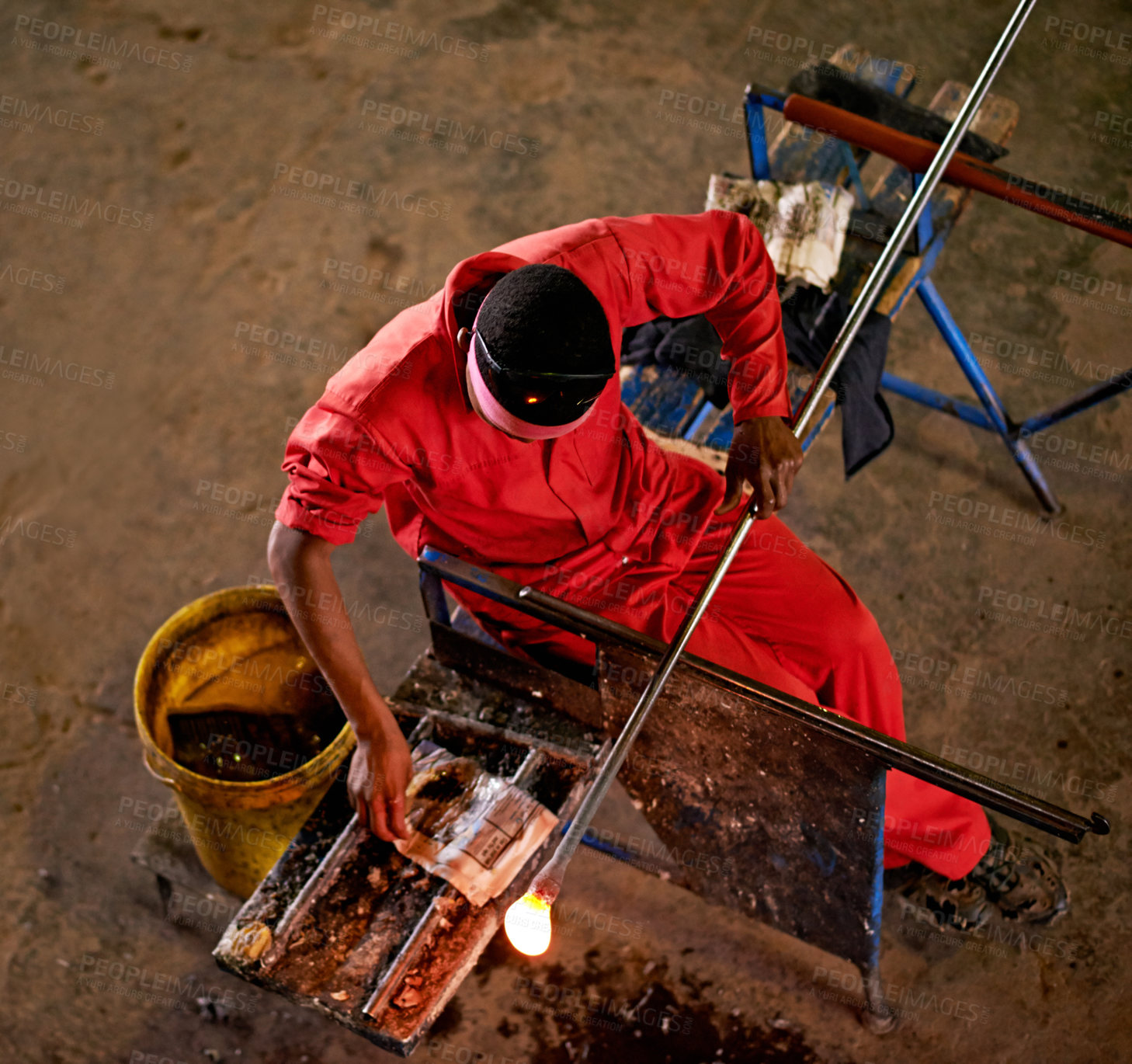 Buy stock photo Above, glassblower and man in factory, equipment  and heat with craftsmanship, material and industry. Person, technique and employee in workshop, manufacturing and tools with productivity and process
