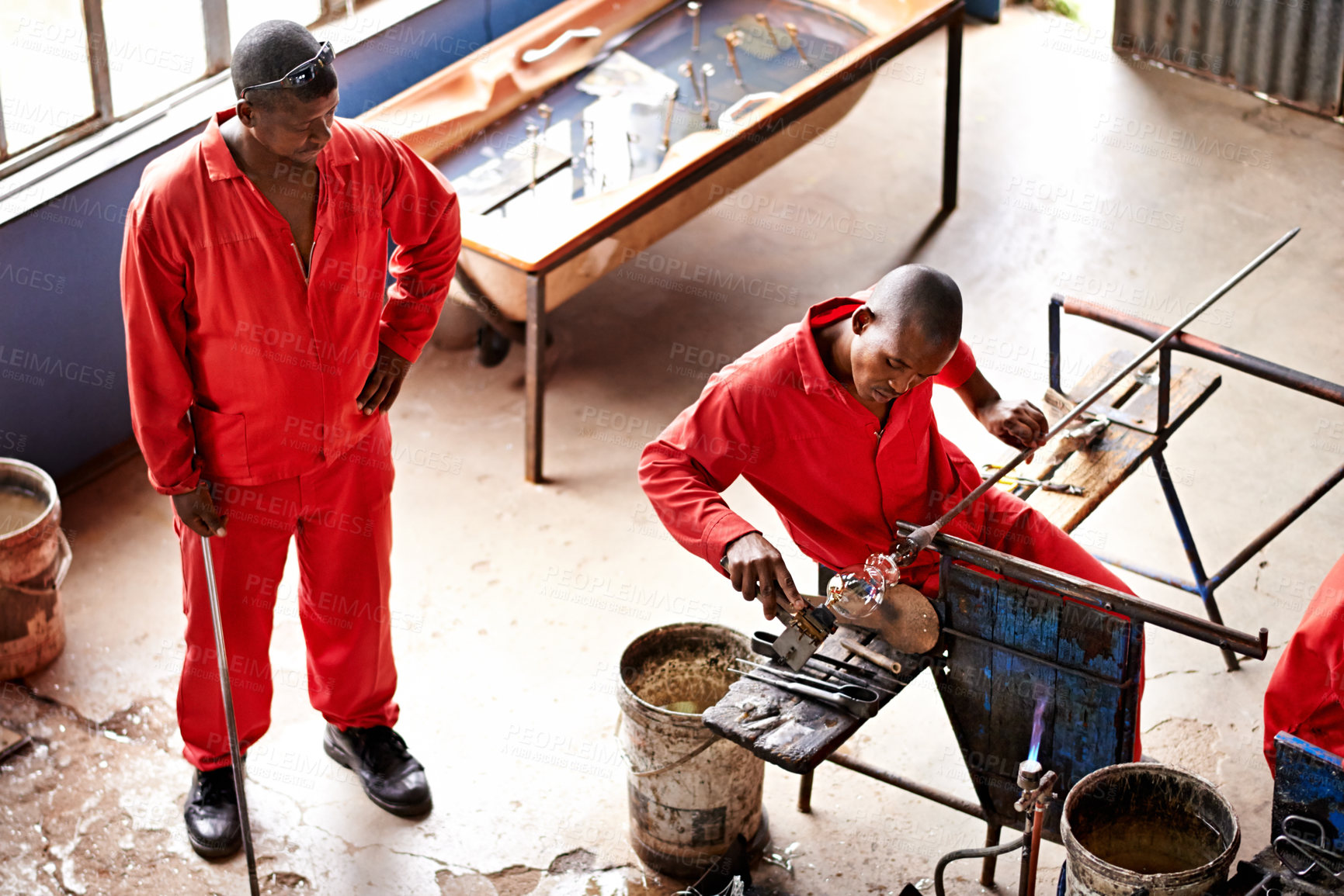 Buy stock photo Glassblowers, vase shape and man in workshop with equipment, professional craft and production. Industrial, factory or top view of artisan molding object with tools for manual labor or manufacturing