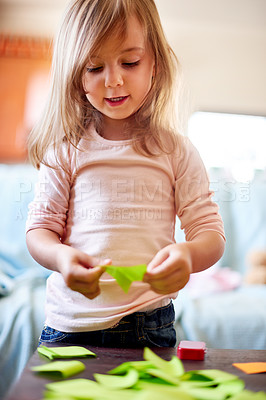 Buy stock photo `Creative, girl and child in home with sticky note for remote learning, education or mischief. School, artistic or female kid with mess or color paper on table for playing or development for games