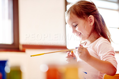 Buy stock photo Child, happy and paintbrush in home for creativity, painting and learning with colors. Young girl, playful and brush in living room for artwork, creative outlet and coordination skill development