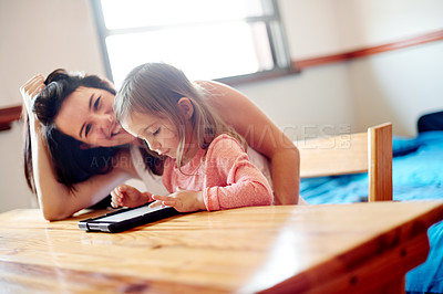 Buy stock photo Mother, daughter and learning with tablet in bedroom for online education, watching cartoon or child development. Woman, girl and tech for streaming service, reading support or gaming app with smile