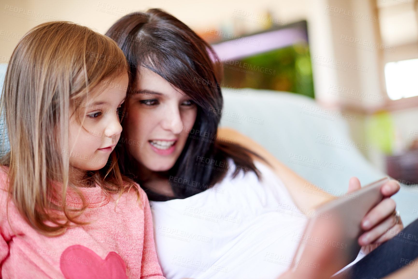 Buy stock photo Woman, kid and relax in home with tablet, memory game app and child development software. Tech, mother and daughter in living room with subscription, streaming media or educational video for learning