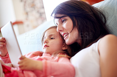 Buy stock photo Mother, daughter and relax with tablet in home for online movie, watching educational cartoon and bonding. Woman, girl child and digital tech for streaming subscription, reading ebook or learning app