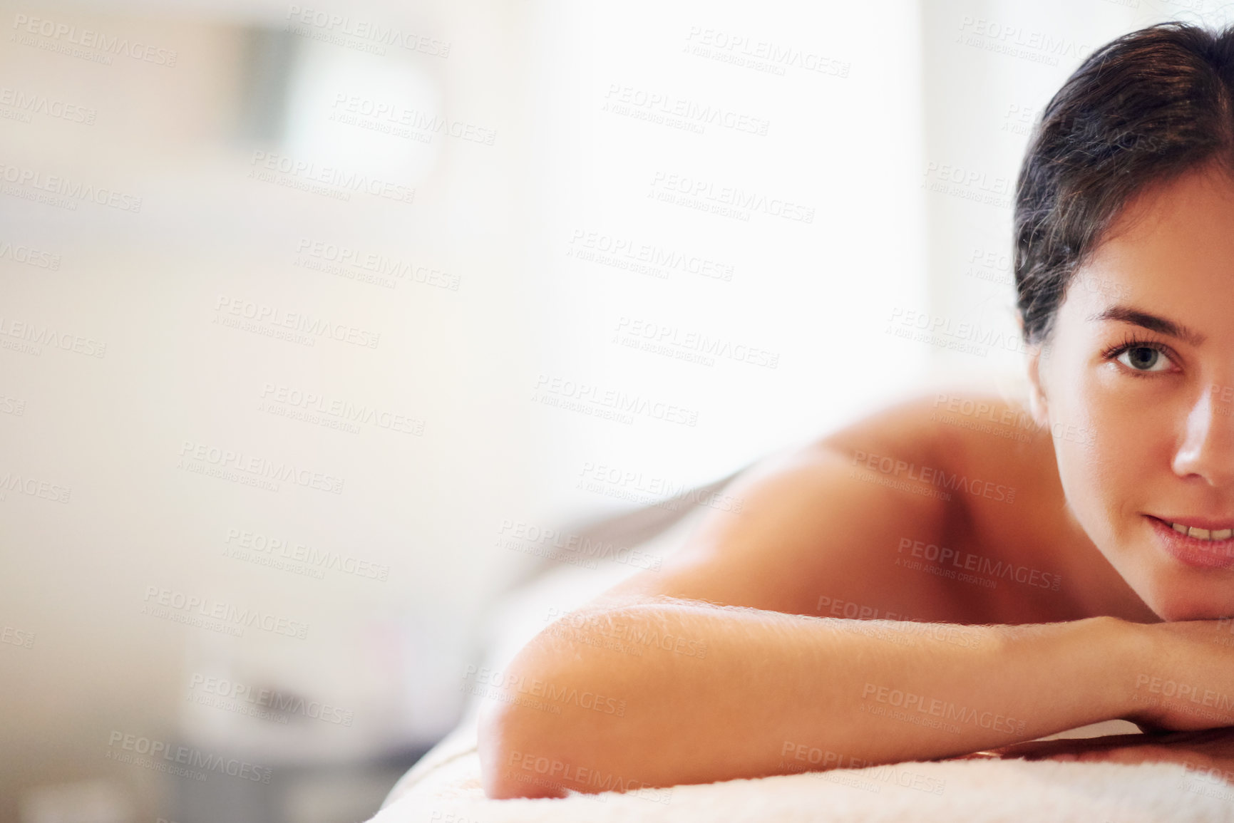 Buy stock photo Relax, zen and portrait of woman at spa with hospitality, peace and space with luxury hotel service. Massage, happy face and calm girl on table at wellness clinic for holistic self care treatment.