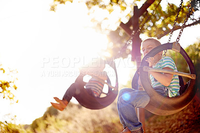 Buy stock photo Development, growth and boy child on swing in playground, having fun with activity, games or play. Adrenaline, excited and hanging with smile of happy kid with brother outdoor at park in summer
