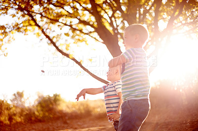 Buy stock photo Game, outdoor and boys with smile, play and nature with happiness, bonding together and energy. Boys in park, kids and children with break, fun and summer holiday with adventure, care and countryside