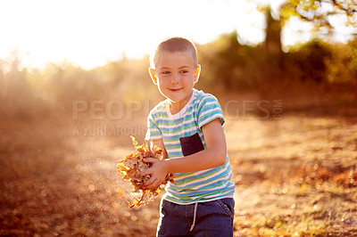 Buy stock photo Happy, playing and child with leaves in park for exploring, imagination or adventure outdoor. Hobby, fun and boy kid with bunch of plants for game in field in Autumn for connection with nature.