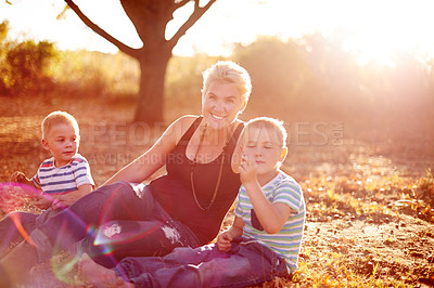 Buy stock photo Children, mother and happy on grass for relax, picnic and summer vacation with lens flare. Woman portrait, kids or family holiday in nature with love, bonding or relationship development for wellness