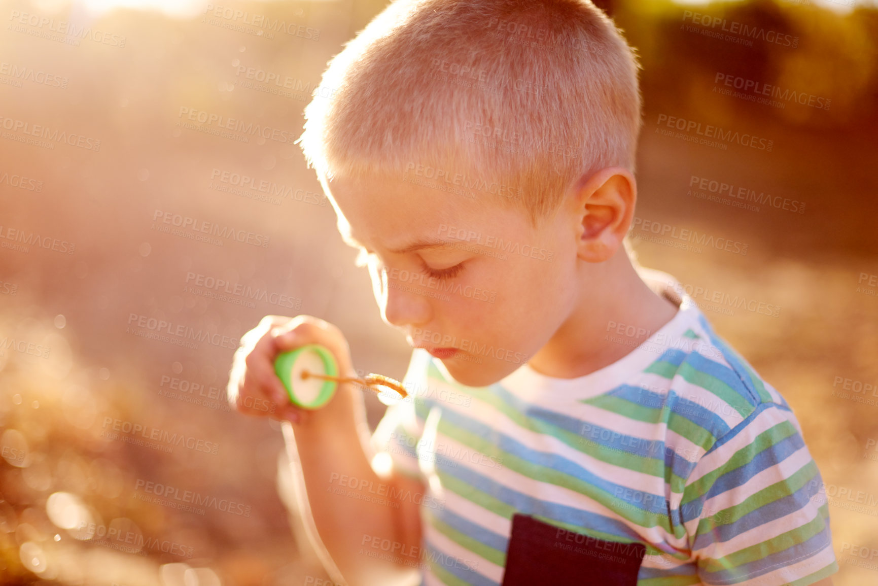 Buy stock photo Bubbles, play and kid in park with fun, sunset adventure or outdoor development for children in nature. Relax, weekend and boy in garden playground with soap wand, childhood games or playful activity