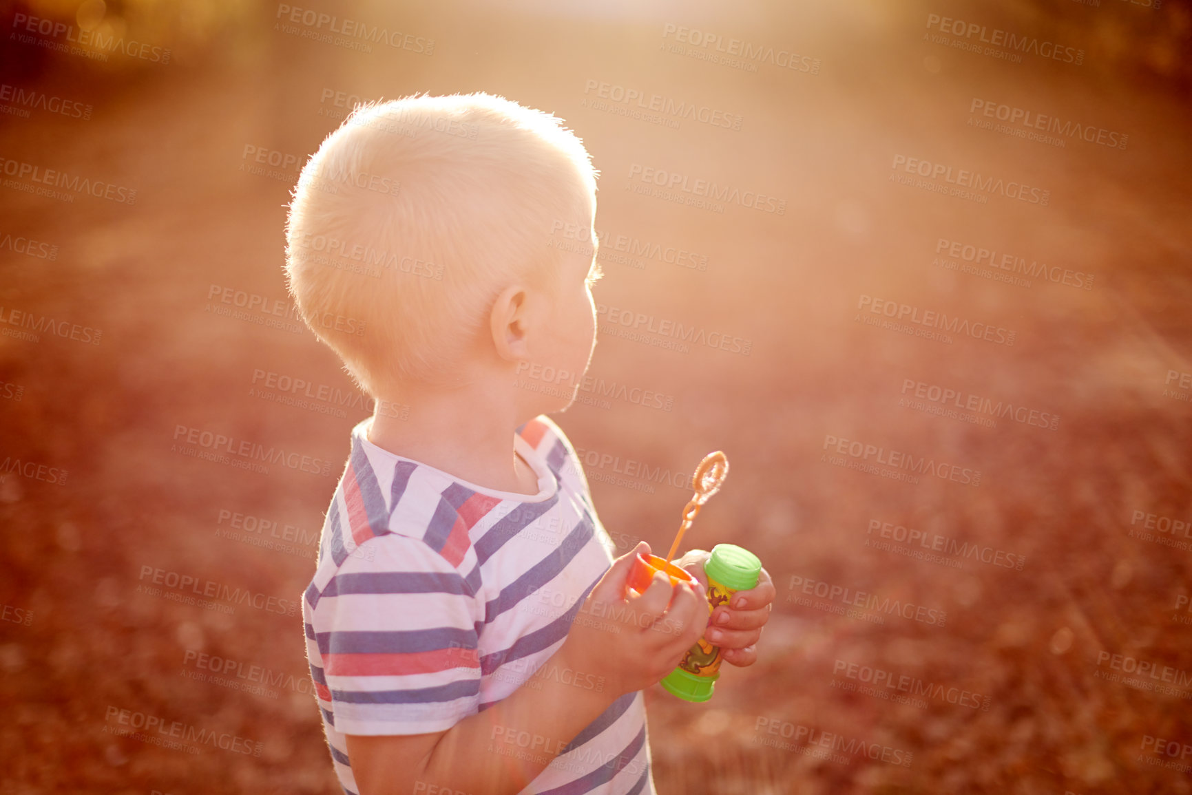 Buy stock photo Boy, child and bubbles at sunset, nature and outdoor at park with game, memory and playful in autumn. Kid, toys and adventure with soap, liquid and foam in garden for with development in Australia