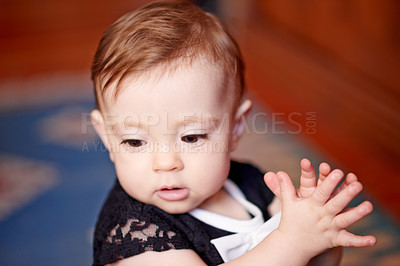 Buy stock photo Cute, baby and girl child in living room for relax, imagine and dream with innocence in lounge. Kid thinking, youth and adorable toddler with growth, healthy development and curious to explore home