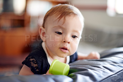 Buy stock photo Baby, girl and playing with toys on bed for playful childhood, explore or youth in development at home. Little child, curious kid or young infant with plastic object for fun activity in nursery house