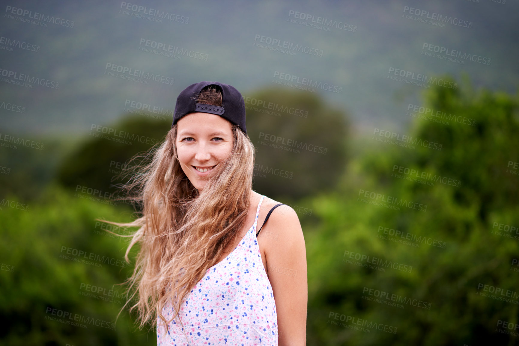 Buy stock photo Wind, portrait and happy woman hiking in nature for travel, adventure and holiday trip in woods. Face, trekking and confident girl in forest for tourism, vacation space and explore Switzerland