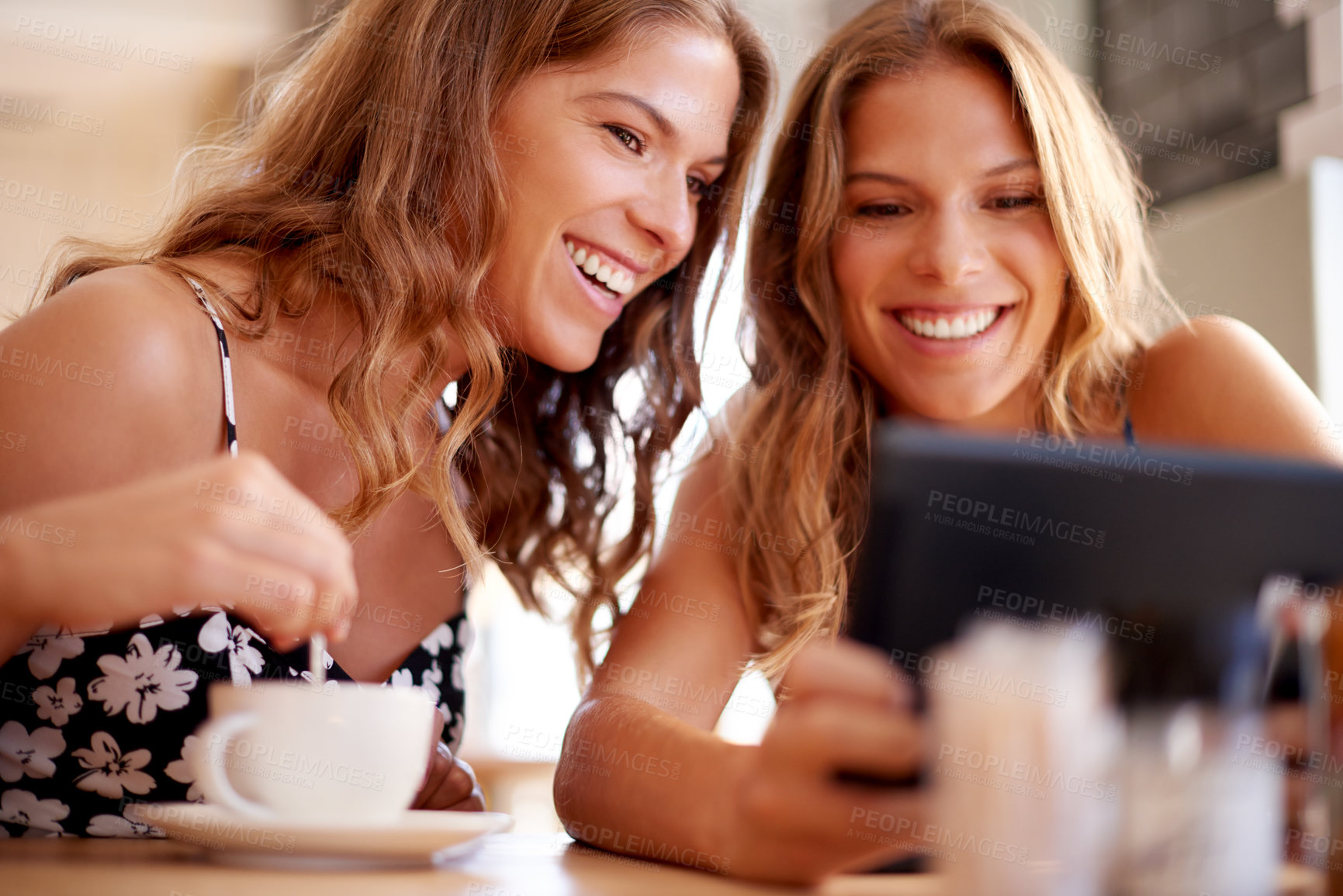 Buy stock photo Women, smile and tablet in cafe for social media, photography and excited for family reunion. Twin sisters, happy and tech in coffee shop for status update, picture memories and bonding on vacation