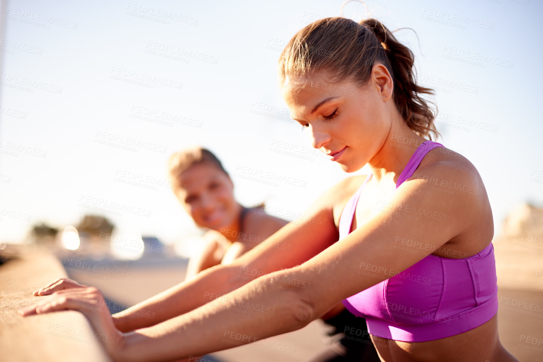Buy stock photo Women, friends or stretching with bridge in city for workout preparation, exercise or training. Active, female people or getting ready with sportswear for fitness warm up, cardio or run in urban town