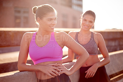 Buy stock photo Fitness, happy twins and women in city for exercise, training and athlete on workout break at sunset. Sports, sisters and outdoor together for body health, wellness and relax with family thinking