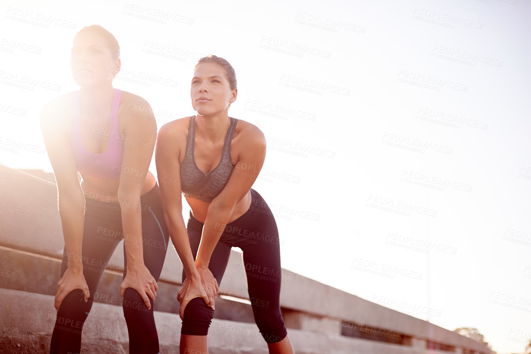 Buy stock photo Fitness, women and relax for exercise outdoor with endurance challenge, performance or break. Mockup space, flare or teamwork with resting from morning jog, marathon competition or recovery on bridge