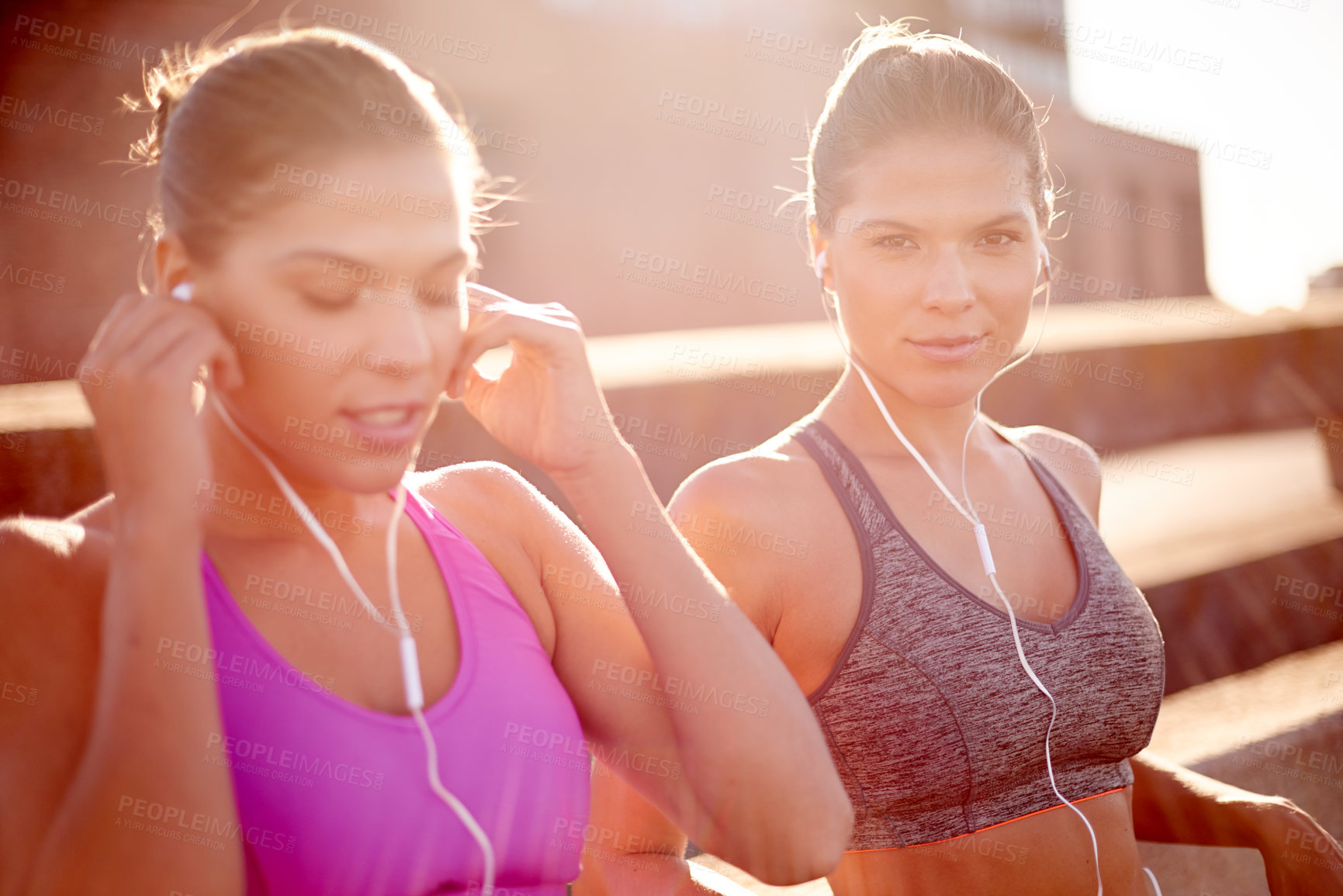 Buy stock photo City, friends and women with earphones, exercise and training with sportswear for routine and outdoor. Streaming, athlete and people with music for workout, together and healthy with audio in morning