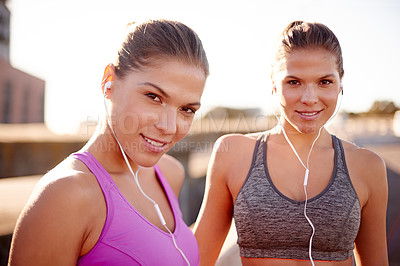 Buy stock photo Women, exercise and together with earphones in city for music, training and sisters in summer. People, runner and twins with streaming, subscription and portrait for workout on urban bridge in Italy